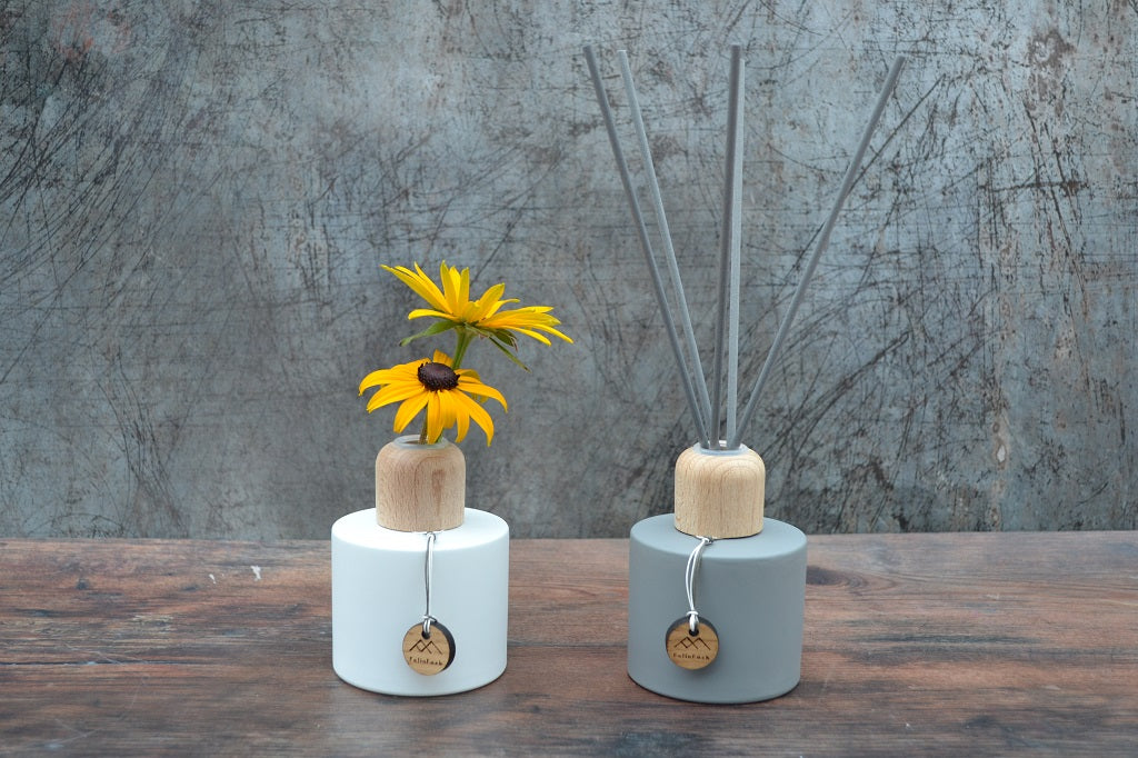 Hand poured reed diffusers in matt grey or white with oak caps.