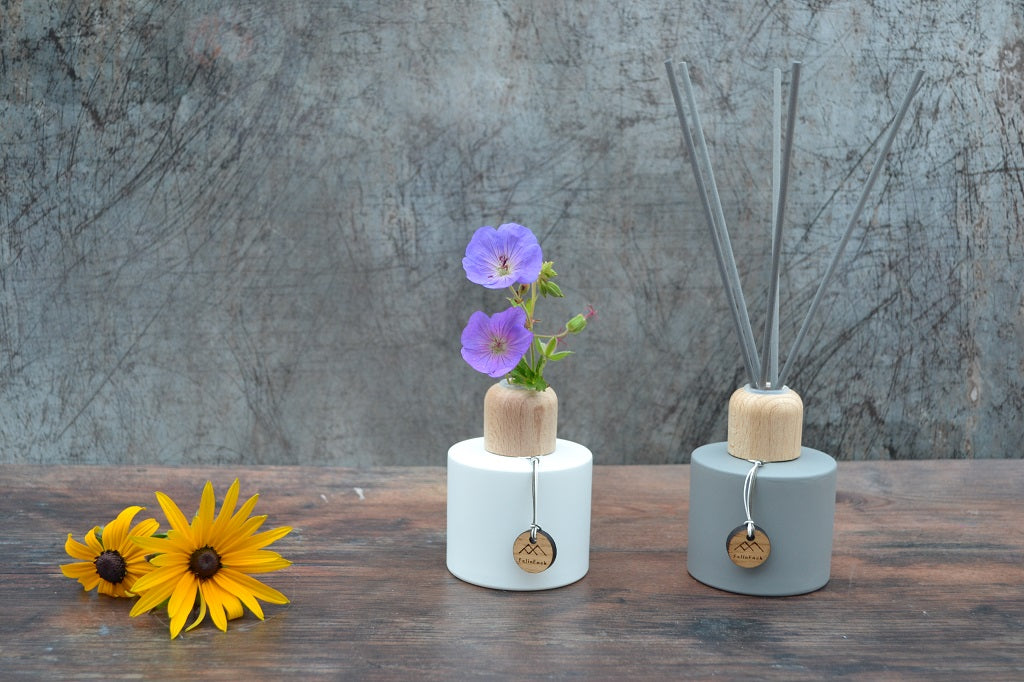 Hand poured reed diffusers in matt grey or white with oak caps..